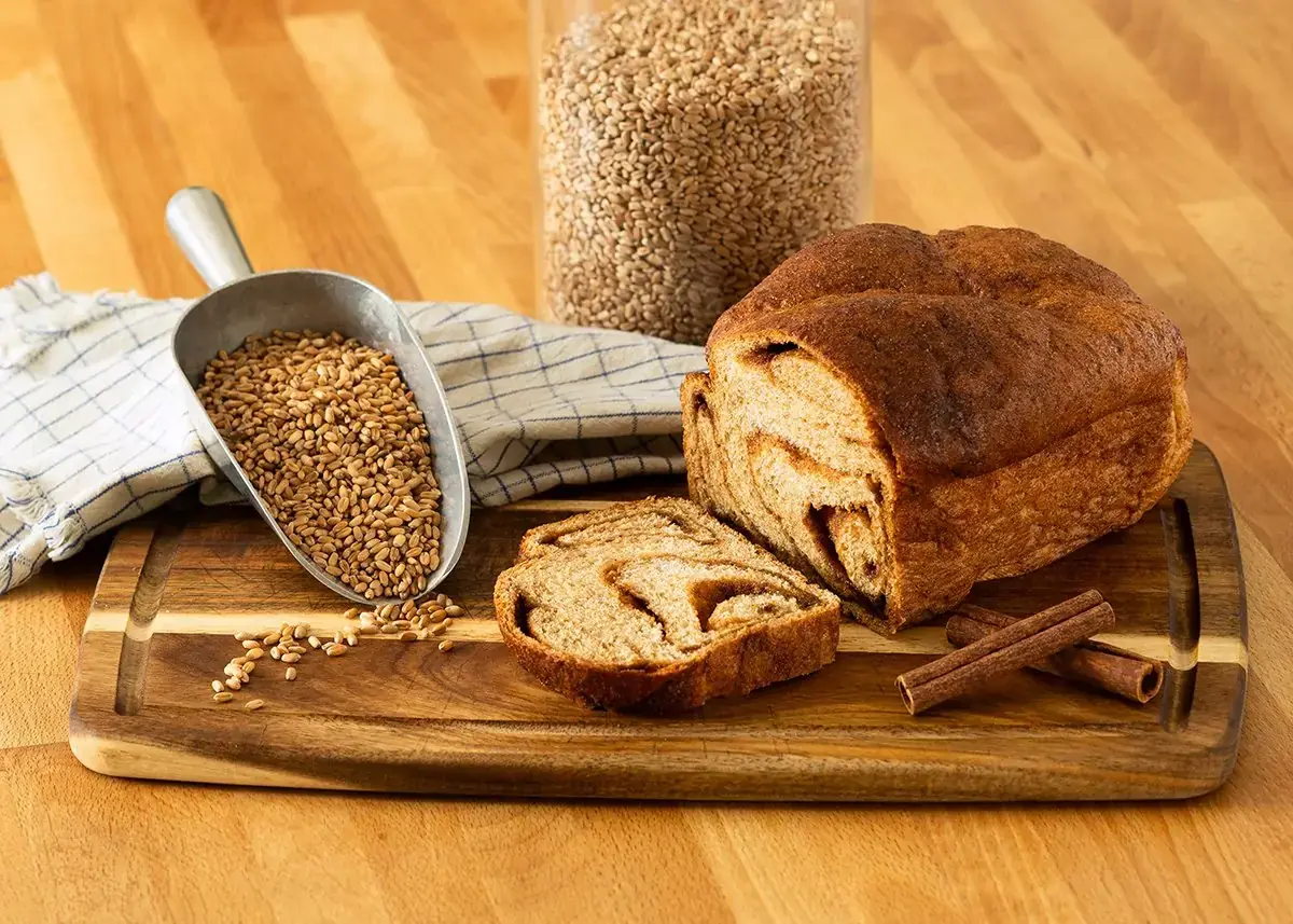 Fresh-milled cinnamon bread, sliced beside the wheat berries it was milled from